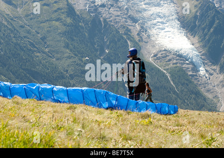 Paraglider pilots prepare for take off from Brevent, in the Chamonix Valley opposite the Mont Blanc Massif, France. Stock Photo