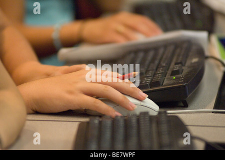 Female hand on mouse Stock Photo
