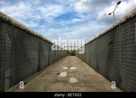 Pedestrian overpass. Metal bridge crossing above the motorway. Stock Photo