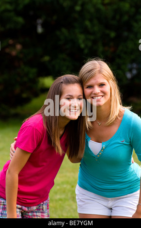 Portrait of modern teenager girls aged 15 to 16 hanging out at home together as friends outside in yard Stock Photo