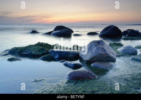 View of stones in water after sunset in the Gulf of Riga Stock Photo
