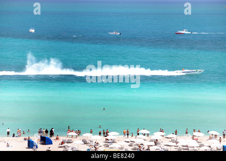People on the beach watching a motor boat racing, South Beach, Miami Beach, Florida, USA Stock Photo