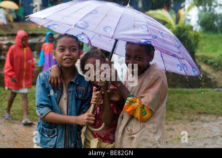 Kids playing in rain hi-res stock photography and images - Alamy