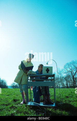 Outdoor office scene, office workers looking at folder together Stock Photo