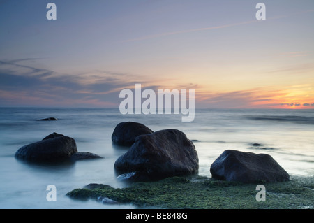 View of stones in water after sunset in the Gulf of Riga Stock Photo
