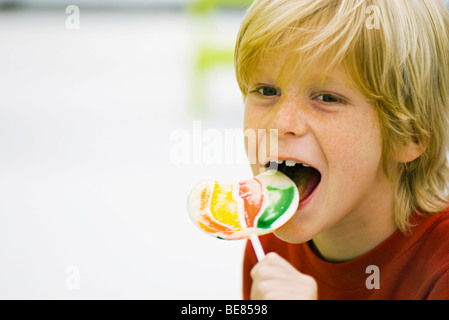 Boy eating lollipop Stock Photo