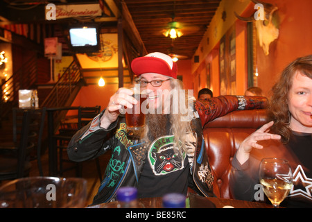 Friends having beers at a local pub laughing and having fun. Stock Photo