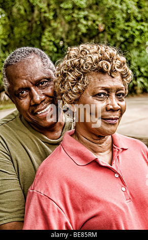 Happy senior african american couple playing doubles on sunny grass ...