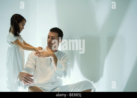 Father and daughter playing rock-paper-scissors Stock Photo