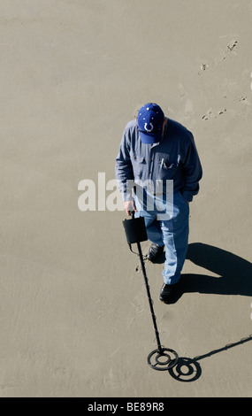 USA Georgia Tybee Island Man using metal detector on sandy beach Stock Photo