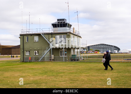 The Control Tower with Aircraft Hangars Behind at Duxford Aerodrome IWM Cambridgeshire England United Kingdom UK Stock Photo