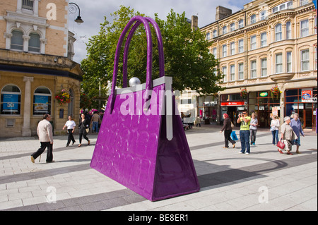 Giant handbag in shopping street to promote opening of new John Lewis store in Cardiff South Wales UK Stock Photo