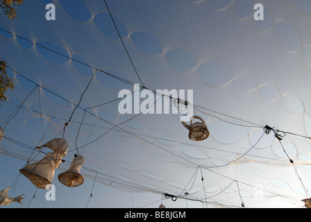 Installation made of Christmas tree netting, power cables and light objects against a blue summer sky, Radebeul Wine Festival,  Stock Photo