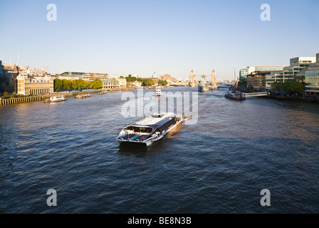 A view of the River Thames looking towards Tower bridge. River cruise boat, Meteor Clipper. UK. Stock Photo