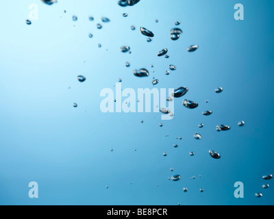 Oxygen bubbles rising to the surface of water Stock Photo