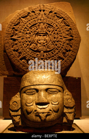 Aztec sculpture with Aztec calendar stone in background, Sala Mexica, National Museum of Anthropology, Mexico City Stock Photo