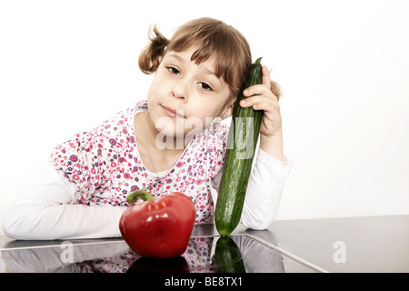 Six-year-old girl holding vegetables in hand Stock Photo