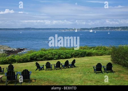 Empty Adirondacks chairs overlooking Narragansett Bay in Newport, Rhode Island. Stock Photo