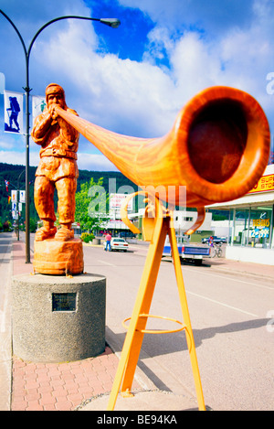 Smithers, BC, Northern British Columbia, Canada - Carved Wooden Alpenhorn Player Statue, Man blowing Alphorn Stock Photo