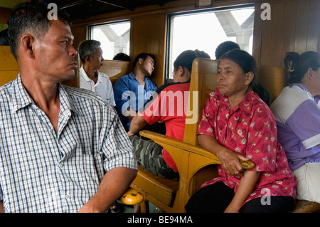 Weary Third-Class train passengers nearing the end of their journey into Bangkok's Hua Lampong Station, Thailand Stock Photo