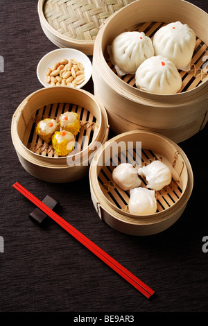 Assortment of dim sum in bamboo steamers. Stock Photo