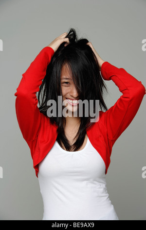 Portrait of young woman playing with her hair. Stock Photo