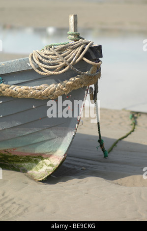 Boat in the sand at low tide Stock Photo