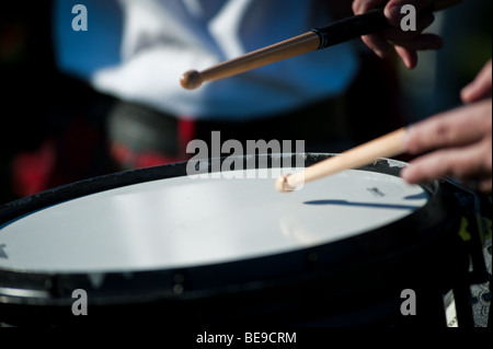 Pipe Band Snare Drummer playing with sticks while marching Stock Photo