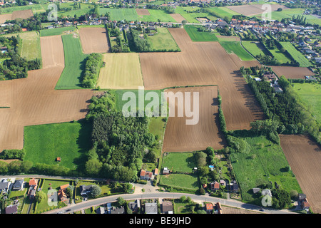 Urbanisation at the border of agricultural area with fields, grasslands and hedges from the air, Belgium Stock Photo