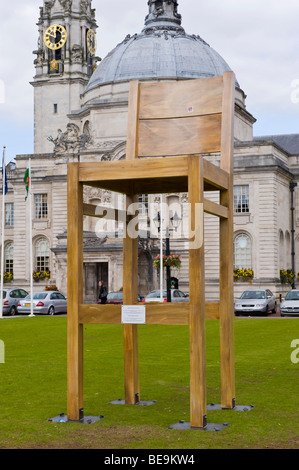 Giant chair on lawn outside City Hall to promote opening of new John Lewis store in Cardiff South Wales UK Stock Photo