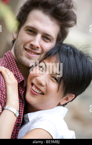 Happy young interracial couple hugging Stock Photo