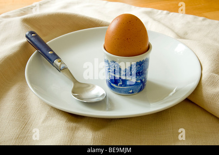 An organic boiled egg, sitting in a blue and white Spode egg cup, a light breakfast, and a good healthy way to start the day. Stock Photo