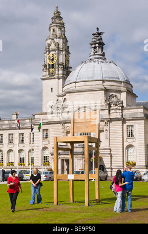 Giant chair on lawn outside City Hall to promote opening of new John Lewis store in Cardiff South Wales UK Stock Photo