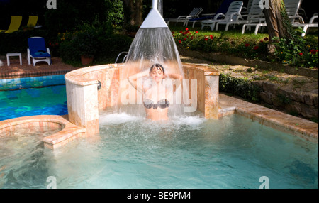 A Woman under a swimming pool shower at the Hotel Astoria in Montecatini Terme, Tuscany, Italy Stock Photo