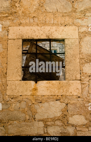 Croatia; Hrvartska; Kroatien; Šibenik-Knin, Privč, Šepurine, window framed with large stone blocks, in stone wall, iron bars Stock Photo