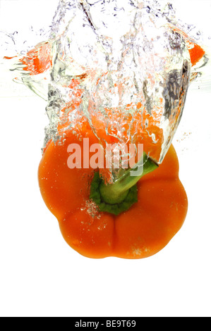 Orange pepper dropped in water isolated on a white background Stock Photo