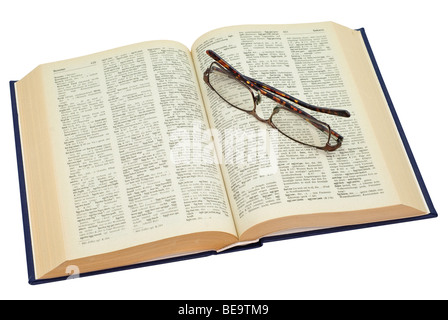 open yellowed old book with glasses, saved with clipping path Stock Photo