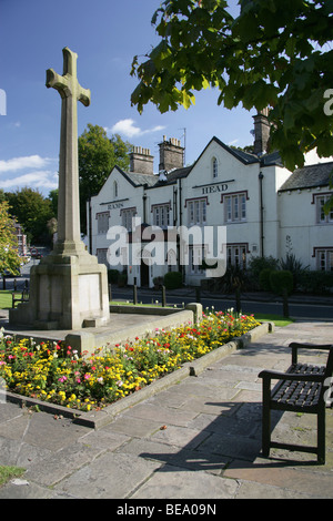 Village of Disley, England. Disley war memorial with the 19th century Rams Head public house in the background. Stock Photo