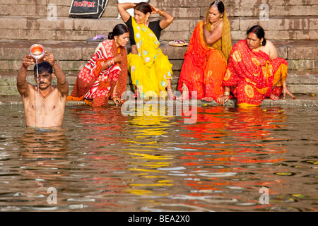Making an offering in the Ganges River in Varanasi India Stock Photo