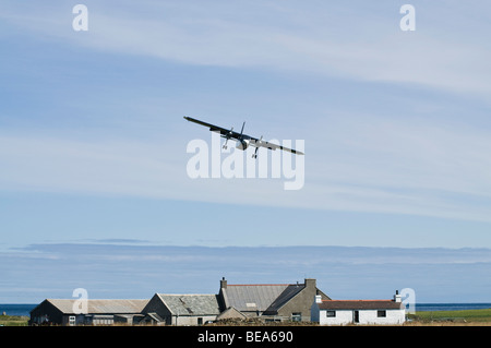 dh Britten Norman Islander NORTH RONALDSAY ORKNEY ISLES Loganair airplane above cottage small plane landing island house remote