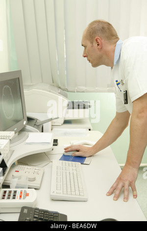 Operator operating computer tomography facility. Magnetic resonance. Stock Photo