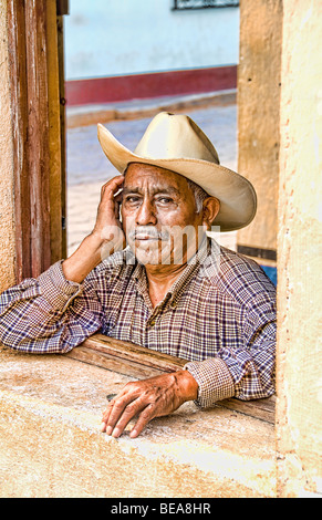 Local humble poor man portrait with cowboy hat in Lake Atitlan village of San Pedro Guatemala in Central America  Stock Photo