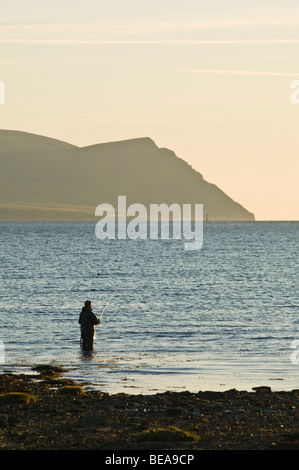 dh Wading fisherman SCAPA FLOW ORKNEY Angler fishing off shore evening Hoy hills scotland