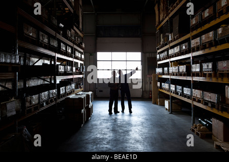 Two manual workers in a metal parts warehouse Stock Photo
