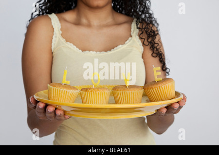 Detail of a woman holding cupcakes Stock Photo