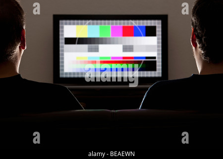 Two men watching a test pattern on a television Stock Photo