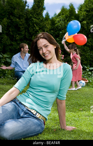Portrait of a woman sitting on a lawn Stock Photo