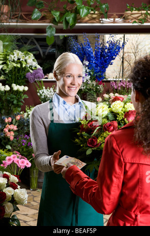 A woman buying flowers in a florist Stock Photo