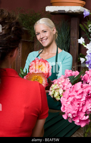 A woman buying flowers in a florists Stock Photo