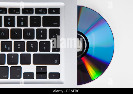 A CD-ROM or DVD halfway in a German laptop Stock Photo